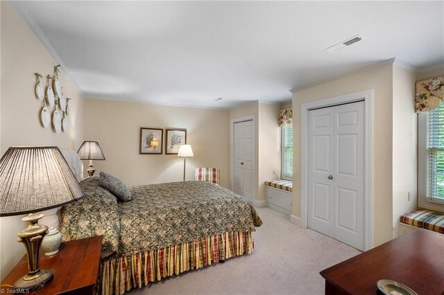 bedroom with light colored carpet and ornamental molding