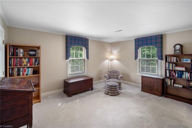 sitting room featuring light colored carpet and ornamental molding