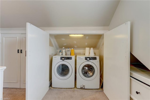 laundry area with laundry area, washer and dryer, and light colored carpet