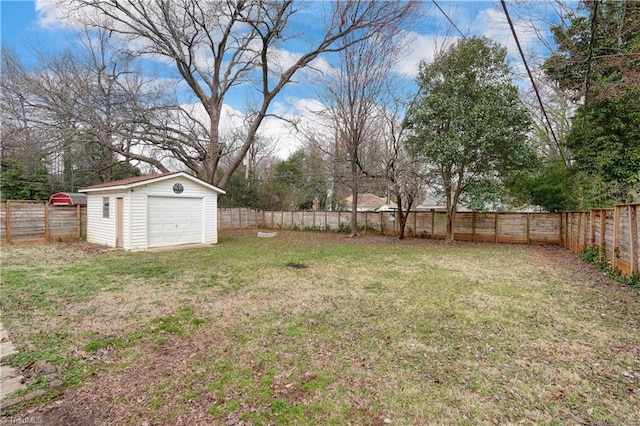 view of yard featuring an outbuilding, a storage unit, a fenced backyard, and a garage