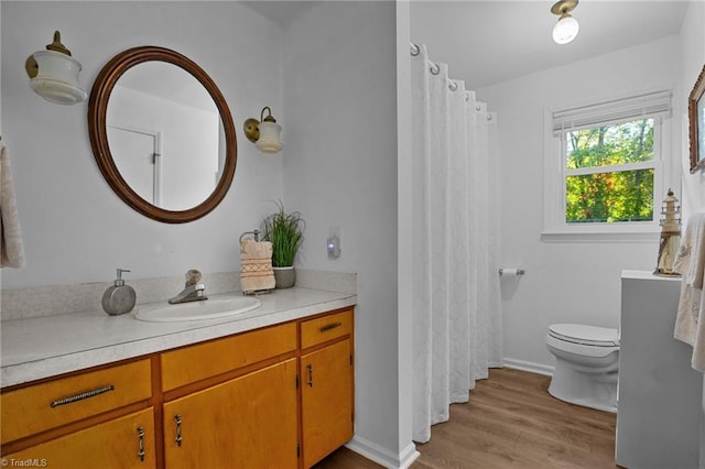 bathroom featuring vanity, toilet, and wood-type flooring