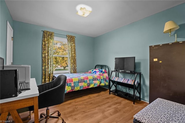 bedroom with hardwood / wood-style flooring