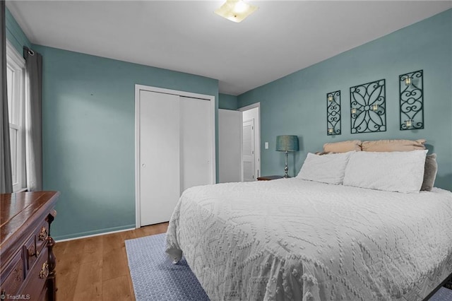 bedroom featuring a closet and dark hardwood / wood-style floors