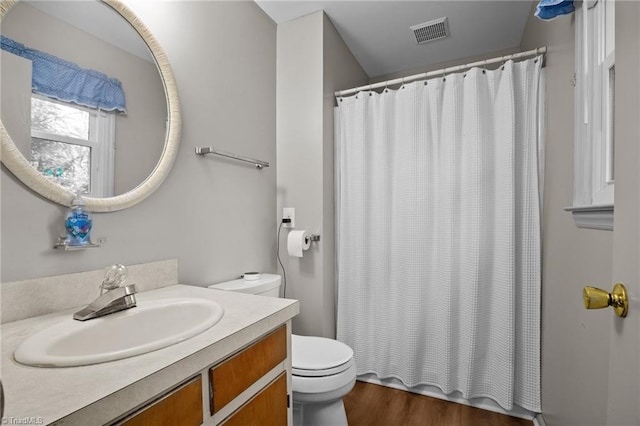 bathroom featuring vanity, hardwood / wood-style floors, a shower with curtain, and toilet