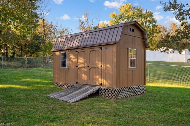 view of outdoor structure featuring a lawn