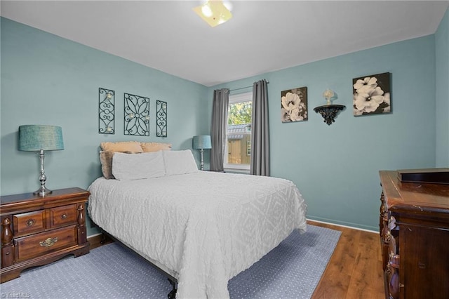 bedroom with dark wood-type flooring