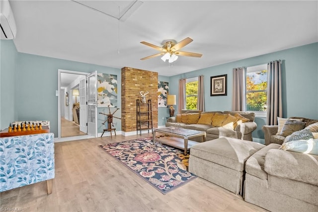 living room with light hardwood / wood-style floors, an AC wall unit, and ceiling fan