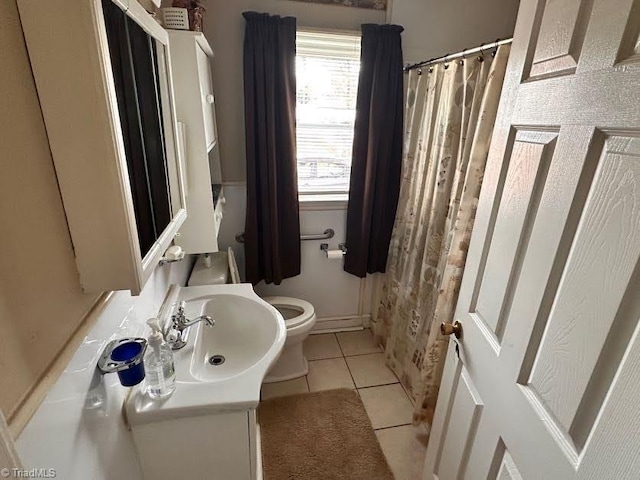 bathroom featuring tile patterned floors, vanity, and toilet