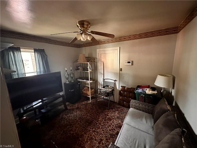 living room featuring ceiling fan and crown molding