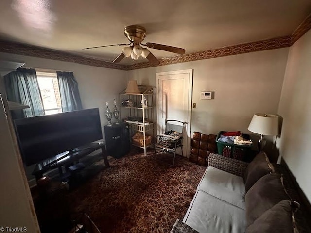 living room featuring ceiling fan and ornamental molding