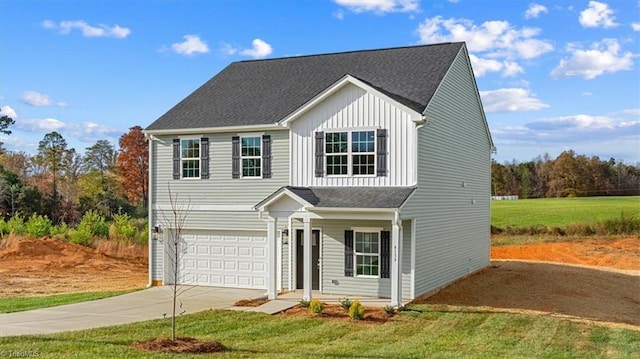 view of property with a front yard and a garage