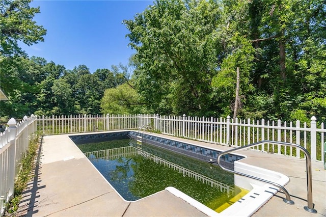 view of swimming pool with a fenced backyard and a patio area