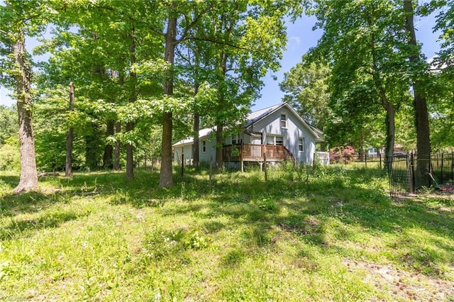 view of yard featuring a wooden deck and fence