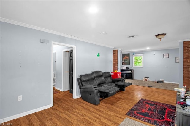 living room featuring ornamental molding, wood finished floors, and baseboards