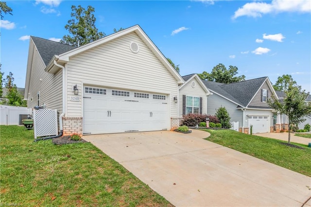 view of front of property with a front yard and a garage