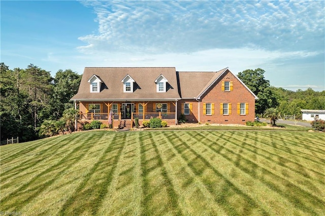 view of front of property with covered porch and a front yard