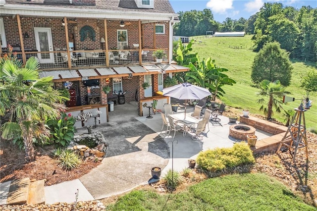 view of patio / terrace featuring an outdoor bar and a fire pit