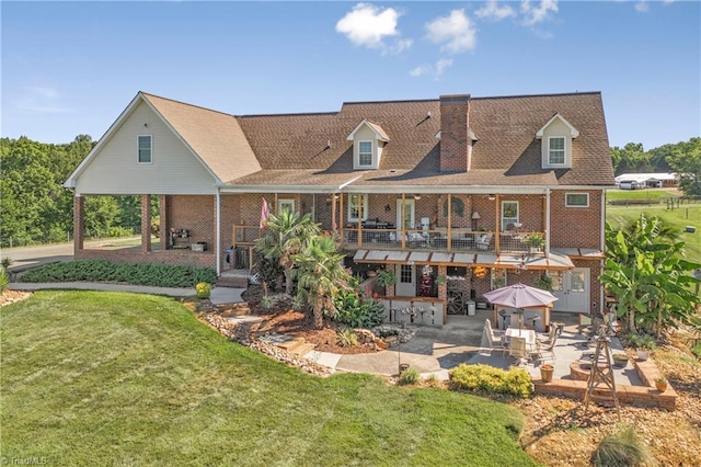 rear view of house with a lawn and a patio area