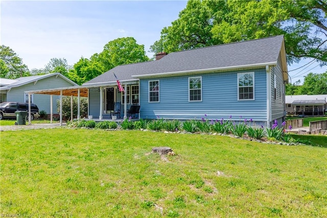 view of front of home with a chimney, a porch, and a front yard