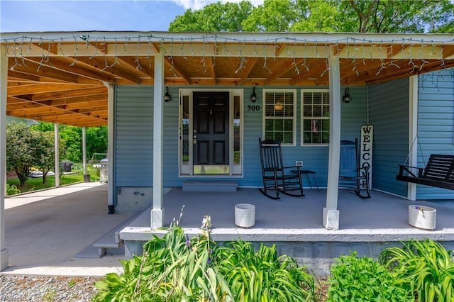 view of exterior entry with covered porch