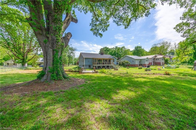 view of yard featuring a deck and fence
