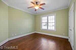 unfurnished bedroom featuring ornamental molding, dark hardwood / wood-style flooring, ceiling fan, and a closet