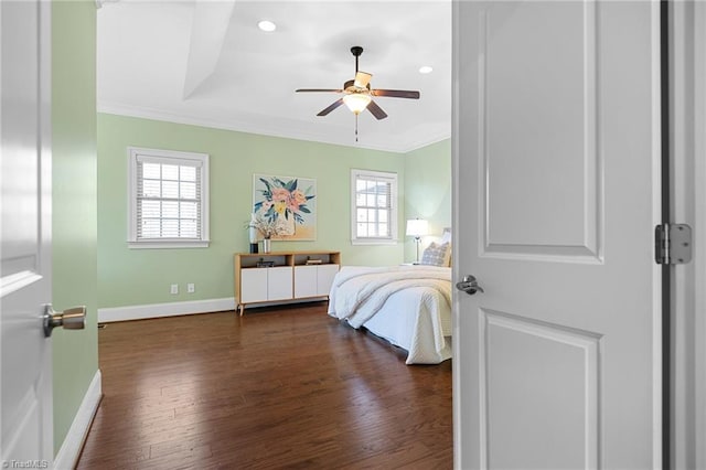 bedroom with multiple windows, crown molding, dark wood-type flooring, and ceiling fan