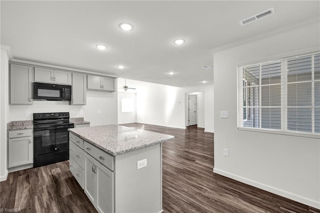 kitchen featuring black appliances, dark wood-type flooring, gray cabinets, and visible vents