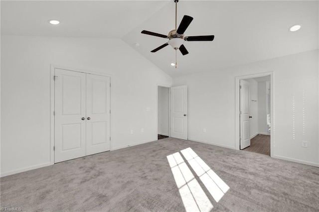 unfurnished bedroom with a closet, vaulted ceiling, carpet flooring, and recessed lighting