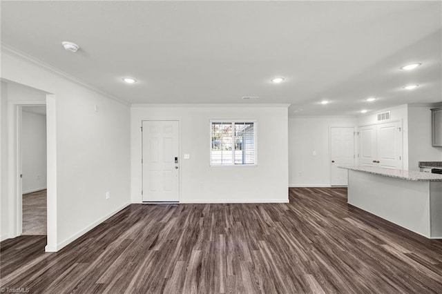 unfurnished living room featuring baseboards, visible vents, ornamental molding, and dark wood-type flooring