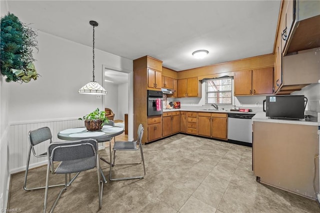 kitchen featuring pendant lighting, stainless steel appliances, and sink