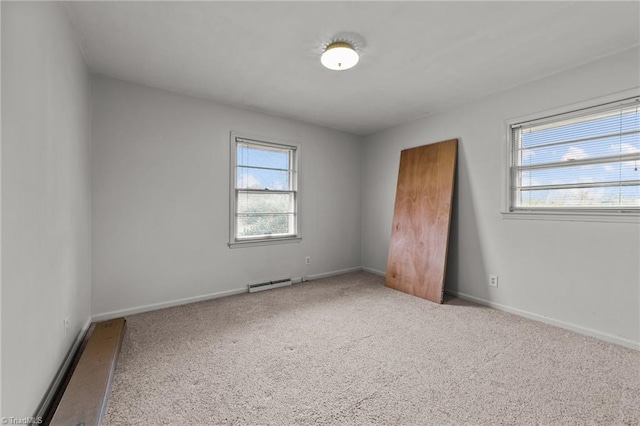 carpeted spare room with baseboard heating