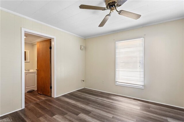 spare room with ceiling fan, crown molding, and dark hardwood / wood-style floors