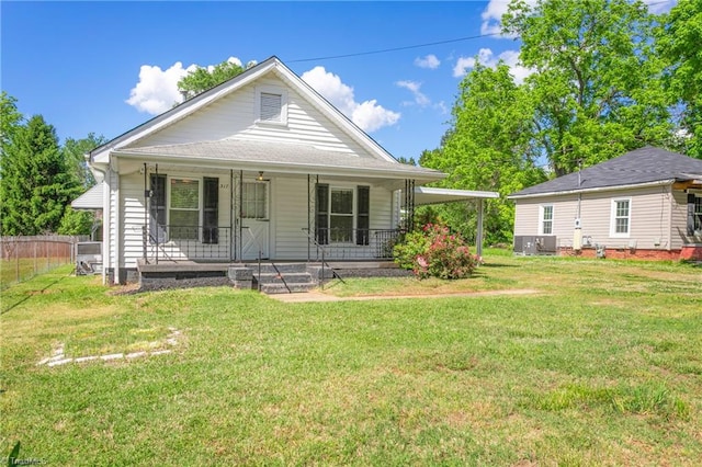 back of house featuring a porch and a lawn