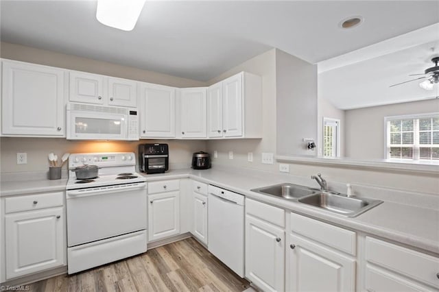 kitchen featuring a sink, white cabinets, a ceiling fan, and white appliances