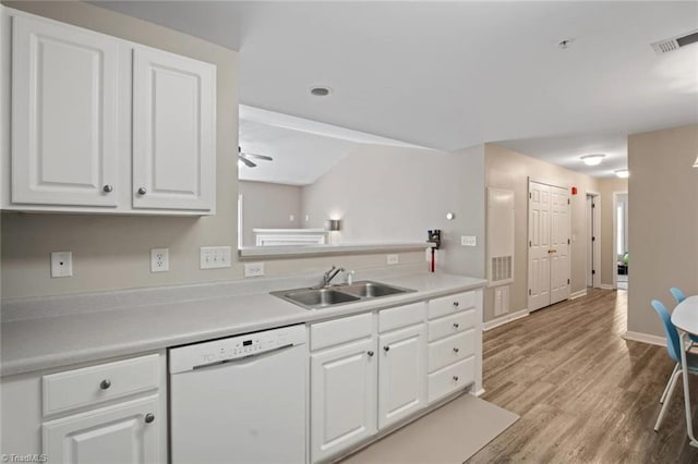 kitchen featuring white cabinets, white dishwasher, a sink, a ceiling fan, and visible vents