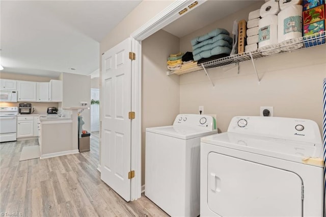 laundry area featuring separate washer and dryer, laundry area, and light wood-style flooring