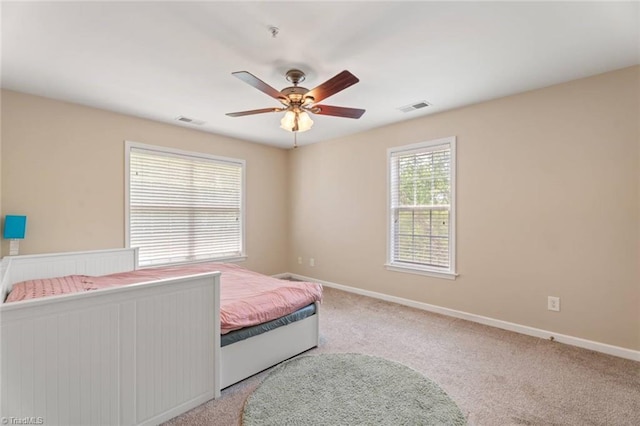 bedroom with visible vents, carpet, baseboards, and ceiling fan