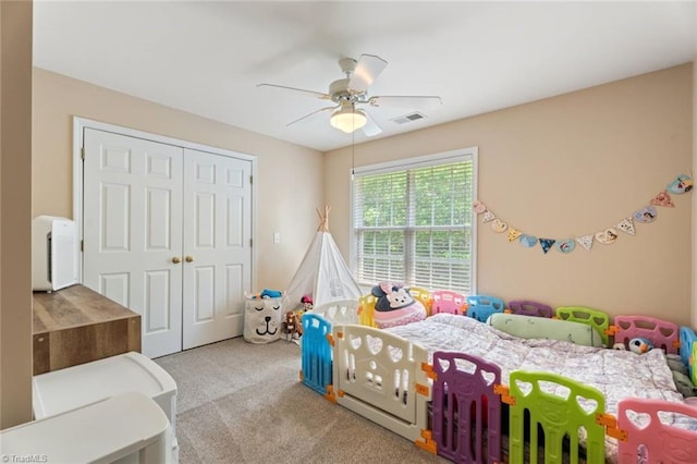 bedroom featuring carpet floors, ceiling fan, a closet, and visible vents