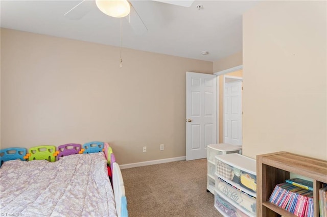 carpeted bedroom with baseboards and a ceiling fan