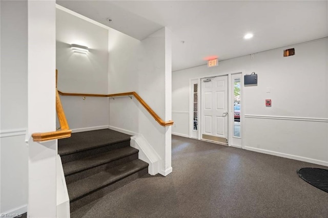 carpeted entryway featuring baseboards, recessed lighting, and stairway
