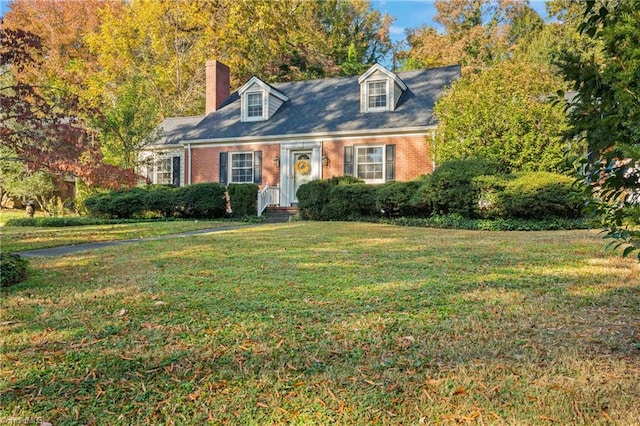 cape cod house featuring a front yard