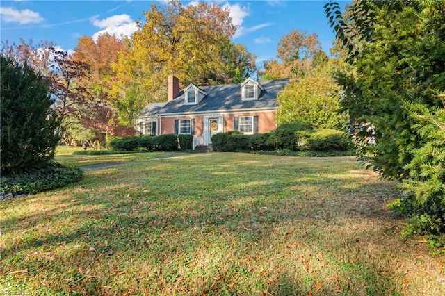 cape cod-style house featuring a front yard