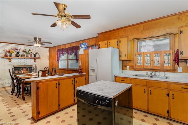 2003 Random Dr, Greensboro, NC 27407 - kitchen with a sink, light floors, white fridge with ice dispenser, light countertops, and wood walls