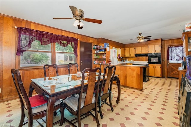 2003 Random Dr, Greensboro, NC 27407 - dining area featuring light flooring, wood walls, and ceiling fan