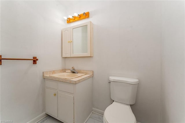2003 Random Dr, Greensboro, NC 27407 - half bathroom with marble finish flooring, baseboards, toilet, and vanity