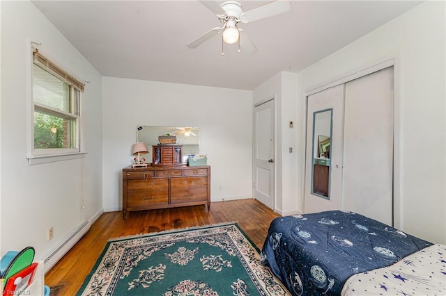2003 Random Dr, Greensboro, NC 27407 - bedroom with baseboard heating, wood finished floors, a closet, and a ceiling fan