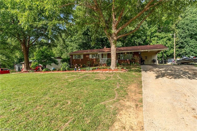 2003 Random Dr, Greensboro, NC 27407 - view of front of home featuring concrete driveway, a front lawn, and a carport