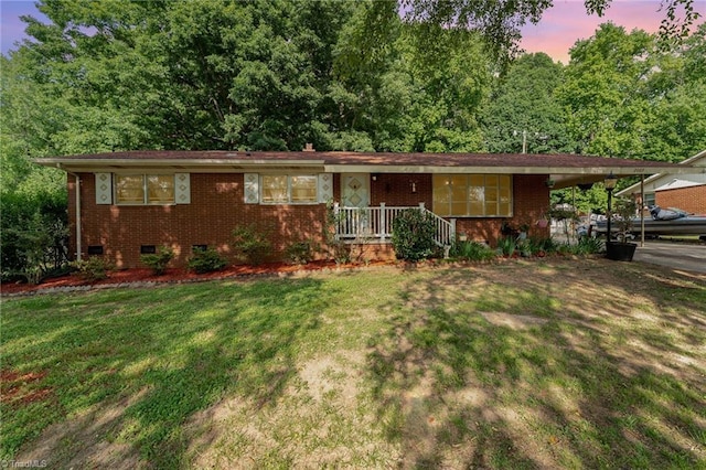 2003 Random Dr, Greensboro, NC 27407 - view of front of house featuring a front yard, brick siding, crawl space, and a carport