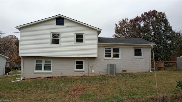 rear view of house featuring a lawn